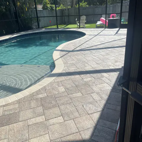 Sealed pool deck pavers inside a screen enclosure
