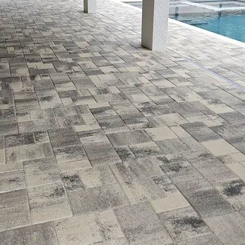 Covered lanai with sealed pavers next to the pool