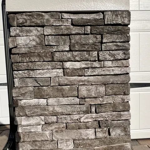 Sealed stacked-stone column at a garage entry